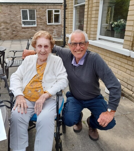 Doris sits in a wheelchair, alongside her cousin, Christopher. Doris has left the Hospice a gift in her Will.